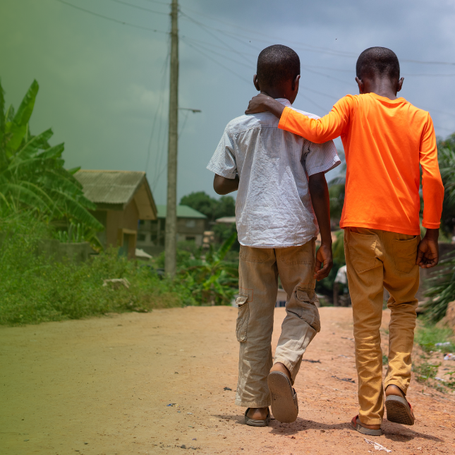 Two boys walking down a road in Nigeria