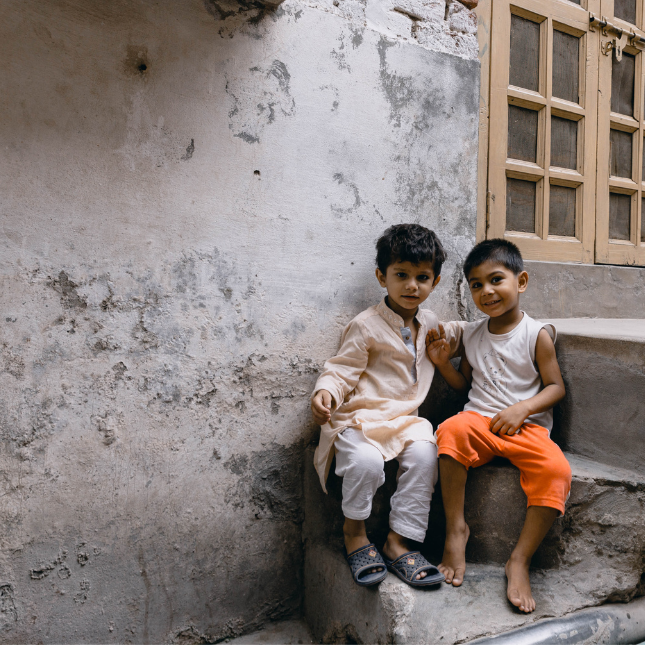 Two boys sitting on steps in Pakistan