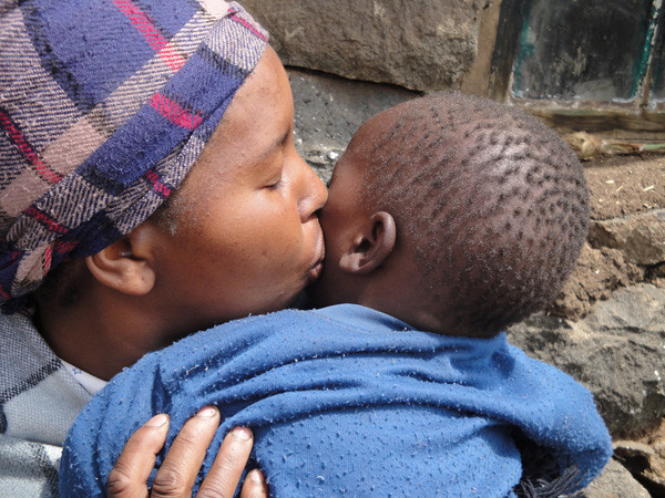 A mother in Lesotho kisses her son