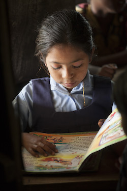 Girl reading book in school uniform in Asia