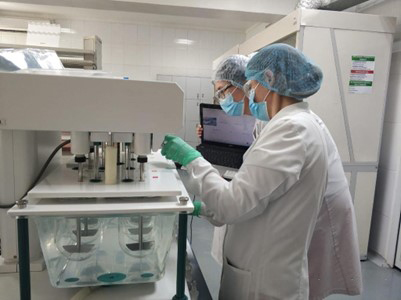 Lab workers using equipment in Kazakhstan