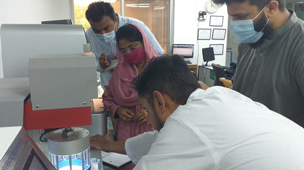 Staff receive training on PPE testing and standards at a testing lab in Pakistan